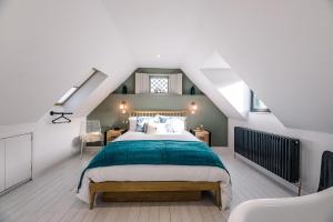 a bedroom with a large bed in a attic at Little Honey Pot in Saxmundham