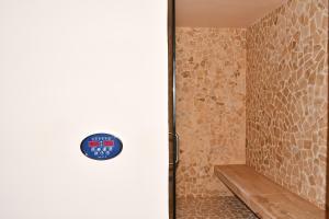 a bathroom with a shower with a clock on the wall at Ceren Luxury Apartments at Fifth Avenue by Spot Rentals in Playa del Carmen