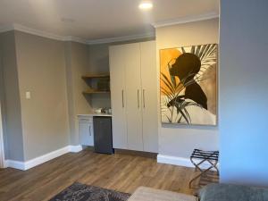 a living room with a painting on the wall at Carthews Luxury BnB in Queenstown