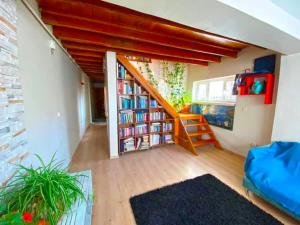 a room with a book shelf and a staircase at Gafa Garden Hostel & Apartments - Great Location in Istanbul