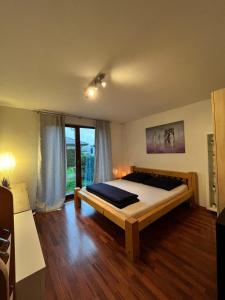 a bedroom with a bed and a large window at Relaxklub villa s wellness in Třemošná