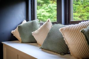 a row of pillows sitting on a window sill at Opulent, relaxing home with Hot Tub in Fochabers