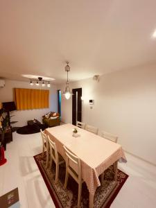 a dining room with a table and chairs at 羽田ハウスⅡ in Tokyo