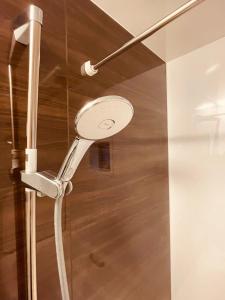 a shower with a shower head on a wall at 羽田ハウスⅡ in Tokyo +34 photos