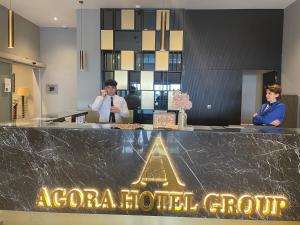 two people standing behind a counter in a hotel room at AGORA ROYAL HOTEL in Esenyurt