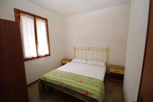 Un dormitorio pequeño con una cama y una ventana. en Apartments in Rosolina Mare 24851, en Rosolina Mare