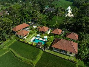 an aerial view of a house with a swimming pool at TAMAN EDEN COTTAGE in Ubud +22 photos
