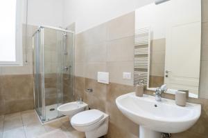 a bathroom with a sink and a toilet and a shower at Nord Milano Luxury Apartments in Bresso