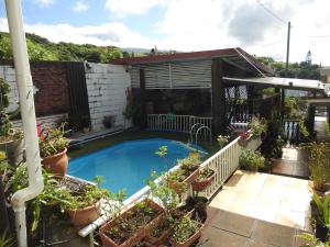 a swimming pool in the backyard of a house at Maison aux portes du Sud Sauvage in Saint-Joseph