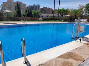 a swimming pool with blue water in a city at ACV Segunda Linea in Oropesa del Mar