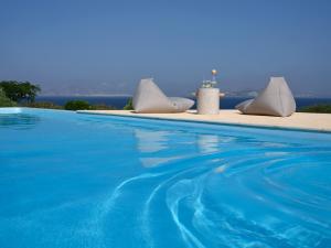 a swimming pool with a view of the ocean at VILLA EKAVI FILIZI - Seaside Residence just outside of Naousa in Naousa