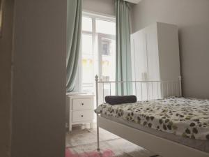 a bedroom with a bed and a dresser and a window at Gafa Garden Hostel & Apartments - Great Location in Istanbul