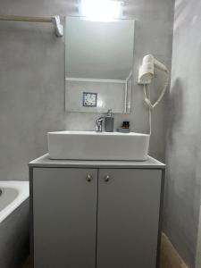 a bathroom with a white sink and a mirror at Agios Eleftherios metro st. 2 bedrms 4 pers. flat in Athens