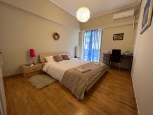 a bedroom with a large bed and a window at Agios Eleftherios metro st. 2 bedrms 4 pers. flat in Athens