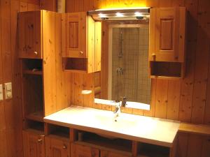 a bathroom with a sink and a mirror at Svarthamar - cabin with amazing view in Al