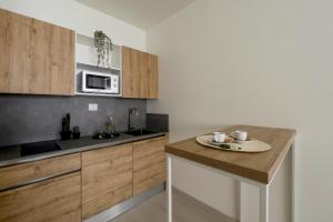 a kitchen with wooden cabinets and a wooden counter top at Hotel Rex in Livorno