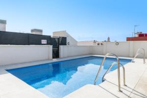 a swimming pool on the roof of a building at -MalagaSunApts- Stylish City Centre Pool&Parking in Málaga