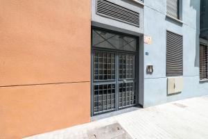 a door on a building next to a sidewalk at -MalagaSunApts- Stylish City Centre Pool&Parking in Málaga