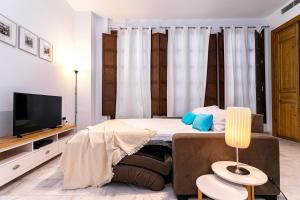 A television and/or entertainment centre at -MalagaSunApts- Premium Historical CityCentre