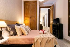 A television and/or entertainment centre at -MalagaSunApts- Premium Historical CityCentre