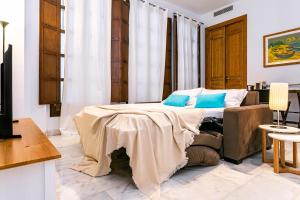 A bed or beds in a room at -MalagaSunApts- Premium Historical CityCentre