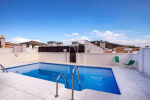 a swimming pool on the roof of a building at -MalagaSunApts- Rooftop Pool in Málaga