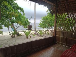 a view of the beach from the porch of a house at Marine homestay in Fam