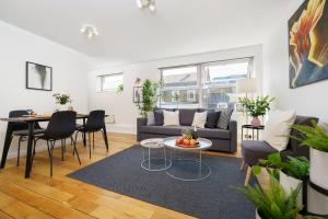 a living room with a couch and a table at Best Location Oxford Str, Soho 2 Bedr, 3 Beds, 2 Bath in London