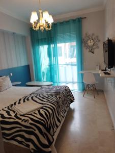 a zebra blanket on a bed in a room with a table at Chambre haut standing in Rabat