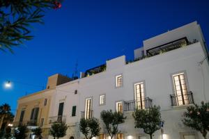 a white building with trees in front of it at Dimora Pirrelli Boutique Hotel & Spa in Monopoli