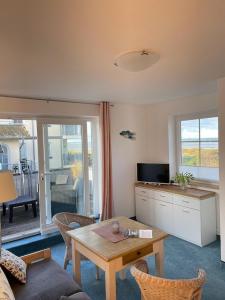 a living room with a couch and a table at Haus Svantekahs in Glowe