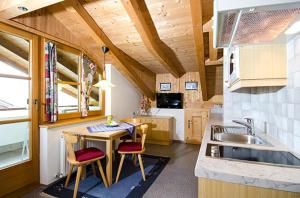 a kitchen with a table and chairs and a sink at Hof am Arlberg - Familie Walter in Sankt Anton am Arlberg