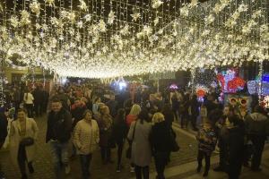 a crowd of people walking through a christmas market at Sweet Homme in Craiova