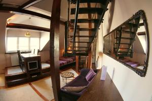 a room with a spiral staircase and a living room at Krakow Jacuzzi Apartment in Krakow