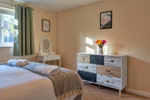a bedroom with a dresser and a bed at Finest Retreats - Southern Lea in Burnham on Sea