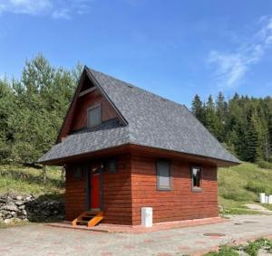 a small house with a roof on top of it at Chata Snežienka in Litmanová