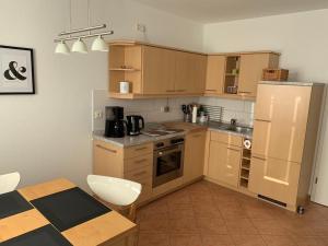 a kitchen with brown cabinets and a table and a table and a table at Am Haferland "Darß-Traum" in Wieck