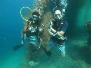 two people in the water with diving equipment at Marine homestay in Fam