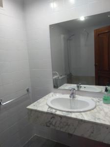 a bathroom with a sink and a large mirror at Club Nautic in Cambrils