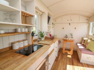 a kitchen with white cabinets and a counter top at Shepherds View in Rhayader