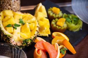 a plate of fruit and vegetables on a table at Daiwa Roynet Hotel Okinawa-Kenchomae in Naha