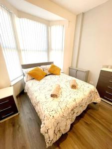 a bedroom with a bed with two towels on it at 8 Guest Lovely home in Liverpool in Liverpool