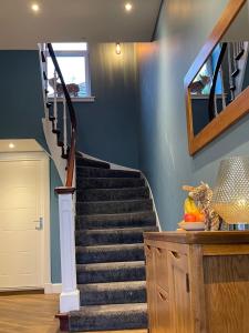 a staircase in a home with blue walls at Killorn Guest House in Oban