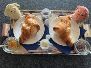 a tray with two plates of croissants on it at GuesthouseOne in Haarlem