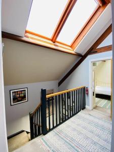 a skylight in a room with a stairway with at Sally Hall Large central Portland home in Portland