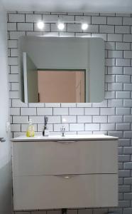 a bathroom with a white sink and a mirror at La Pléiade Dorée - Extra Centre - Wifi HD - Terrasse & Jardin in Amiens