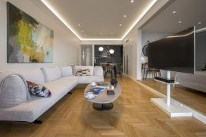 a living room with a couch and a tv at Chic central Athens apartment at Mavilli Sq. in Athens