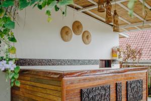 a counter in a kitchen with two baskets on the wall at Shrining Cottages Lembongan in Nusa Lembongan