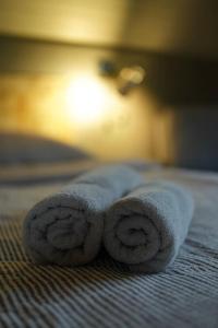 a roll of towels sitting on a bed at CHALET RaJ in Gelnica