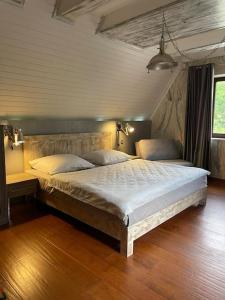 a bedroom with a large bed in a room at CHALET RaJ in Gelnica